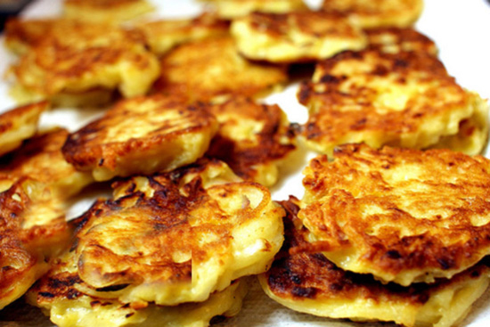 Potato pancakes with goat cheese on mixed greens 