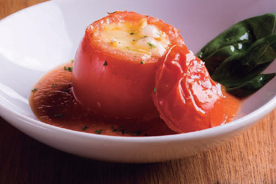 Tomato stuffed with creamy cheese with gazpacho 
